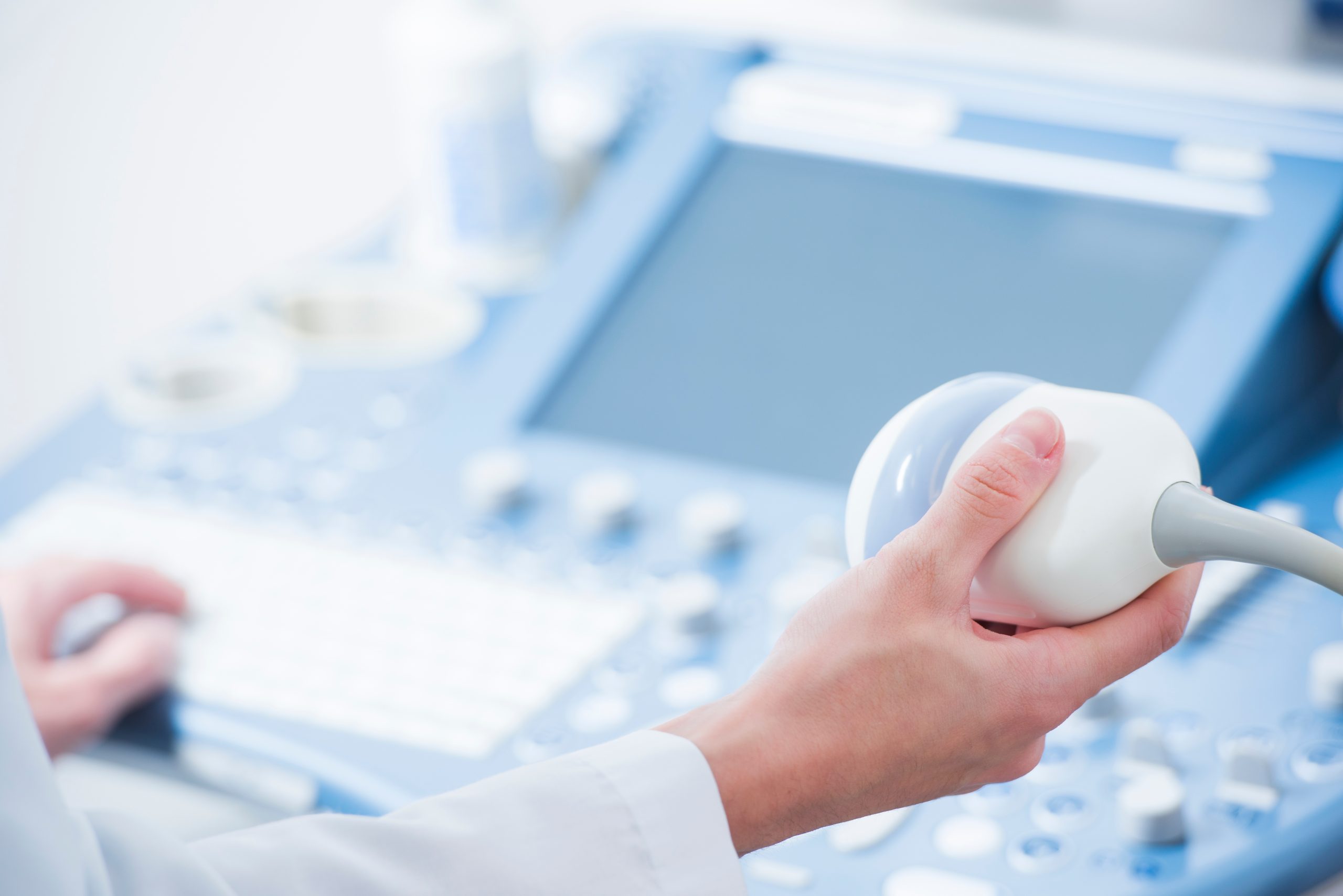 young woman doctor's hands close up preparing for an ultrasound