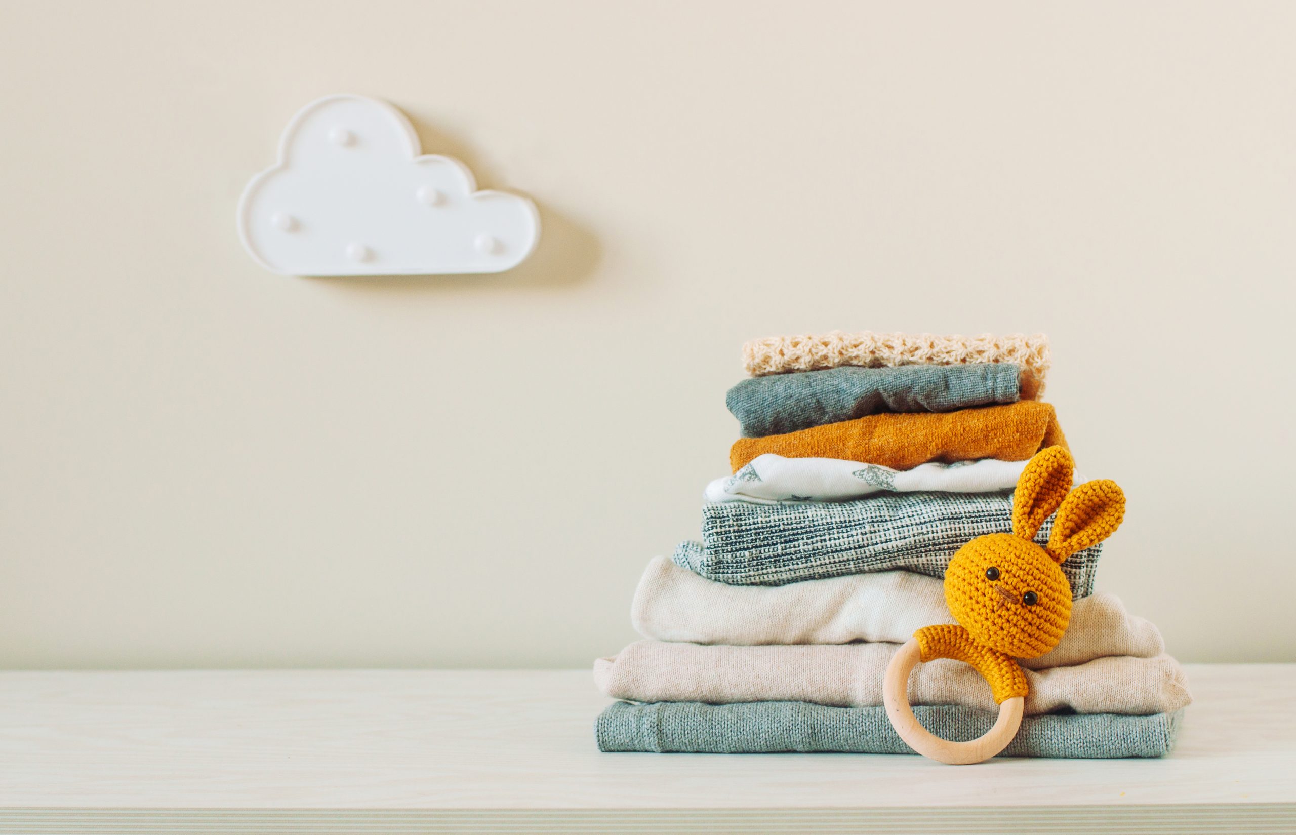 Organic cotton baby clothes on the shelf in the kids room